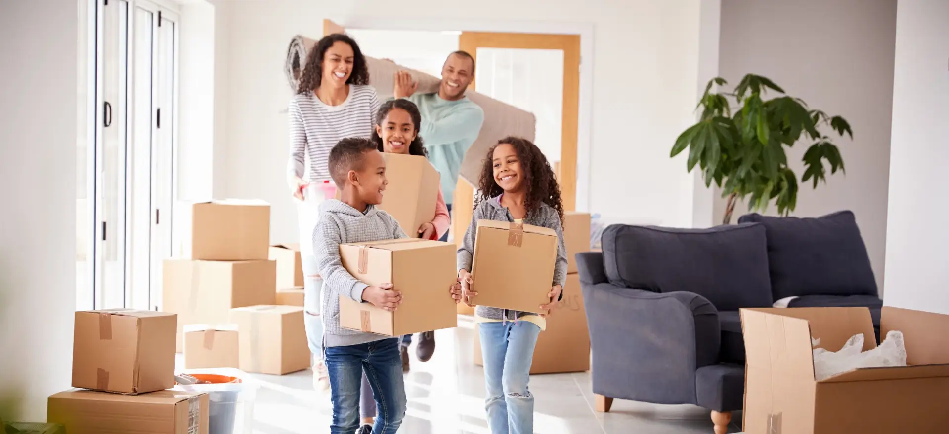 Happy family moving in to their new home thanks to Affiliated Home Loans, Inc.